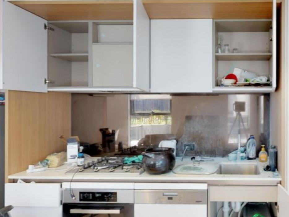 Kitchen with open cupboards and items on the benchtop