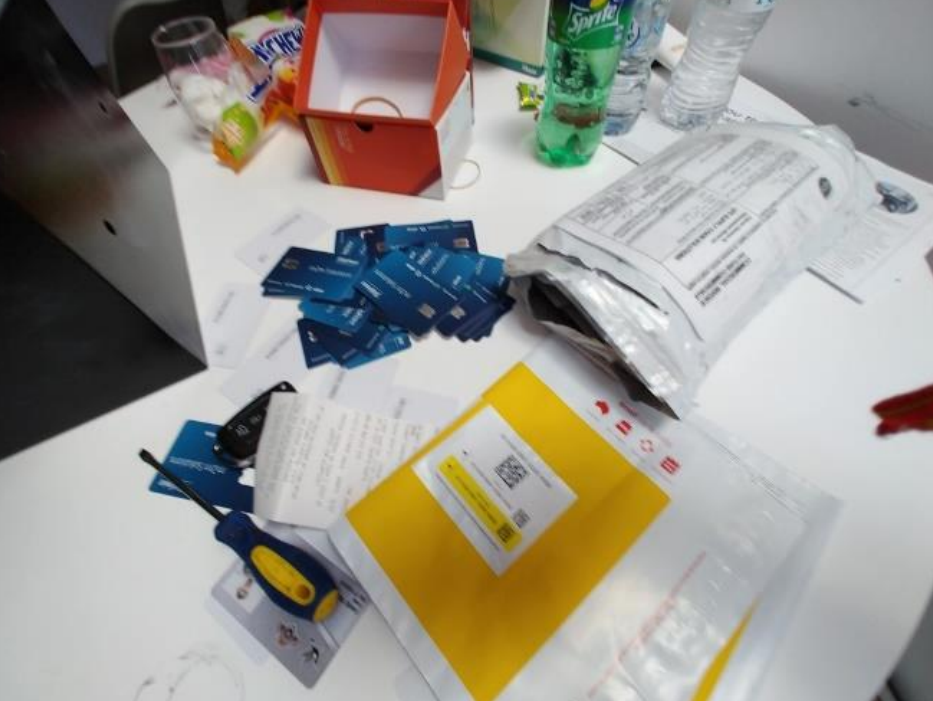 Documents, cards and household items arranged on a table